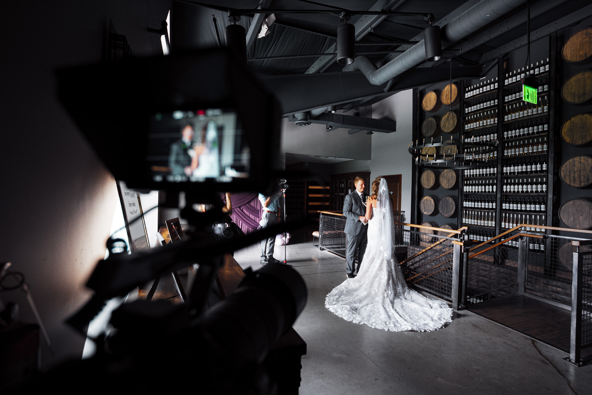 Filming a bride and groom's first look at a winery, seen past the camera monitor
