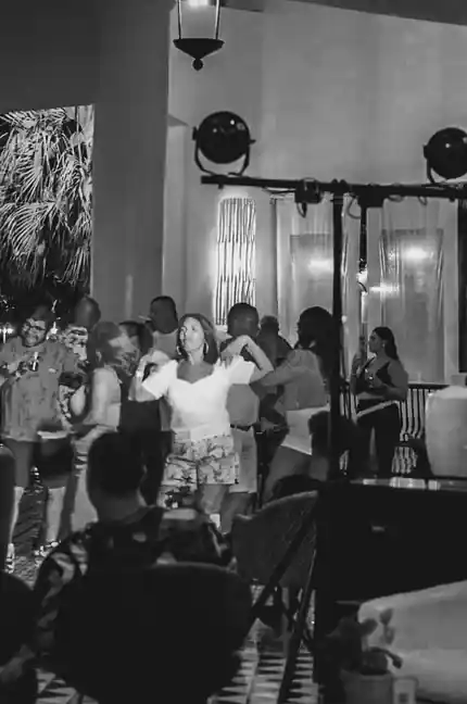 A crowd dancing under stage lighting at an event